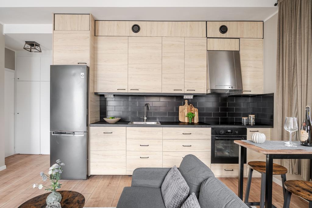 Kök i trä och svart med kaklat stänkskydd