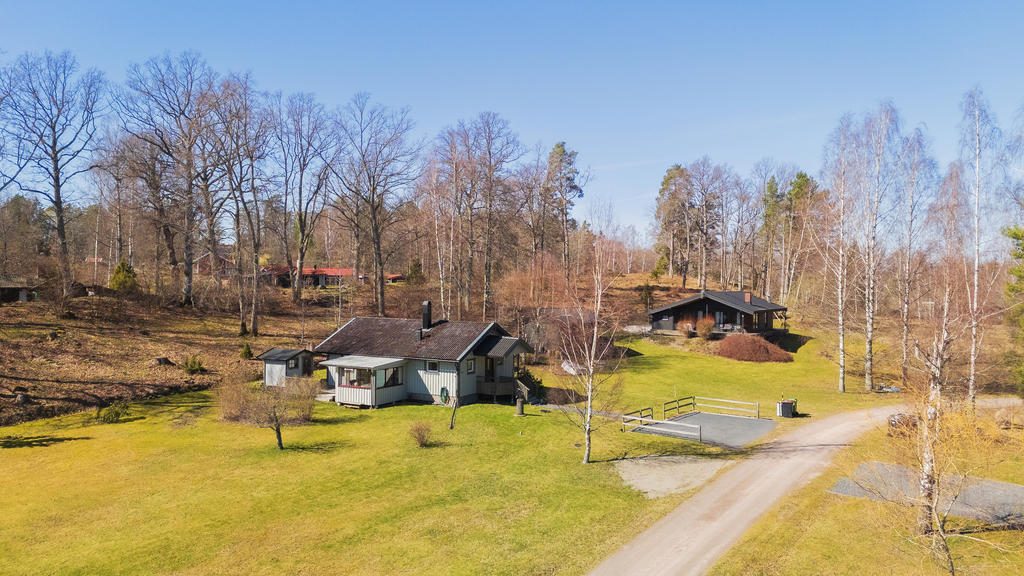Den generösa tomten som omgärdar huset är lättskött och erbjuder både soliga uteplatser, lekvänliga gräsytor och inslag av naturtomt.