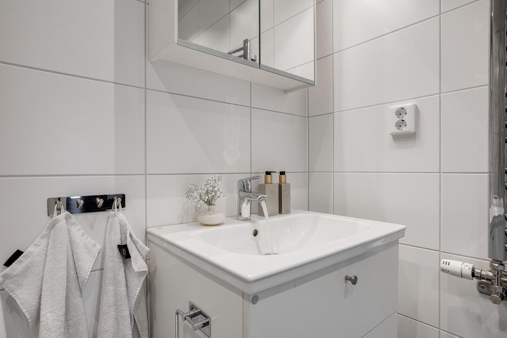 Badrum med kommod och spegelskåp