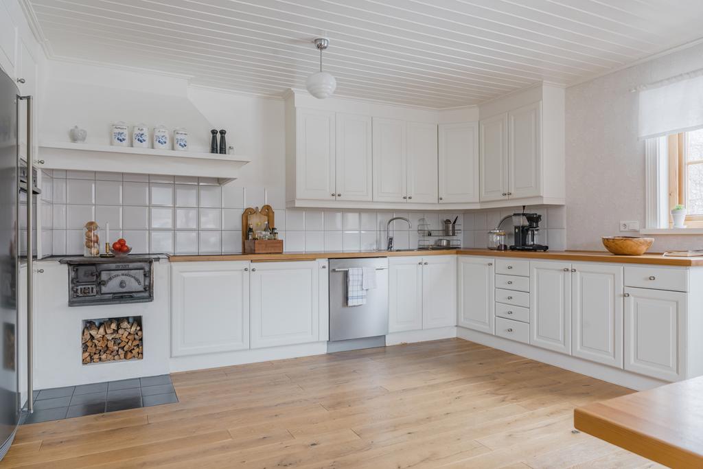 Ett renoverat kök i lantlig stil har fungerande vedspis 