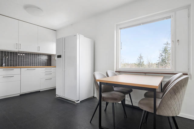 Fräscht renoverat kök med matplats och side-by-side kyl/frys