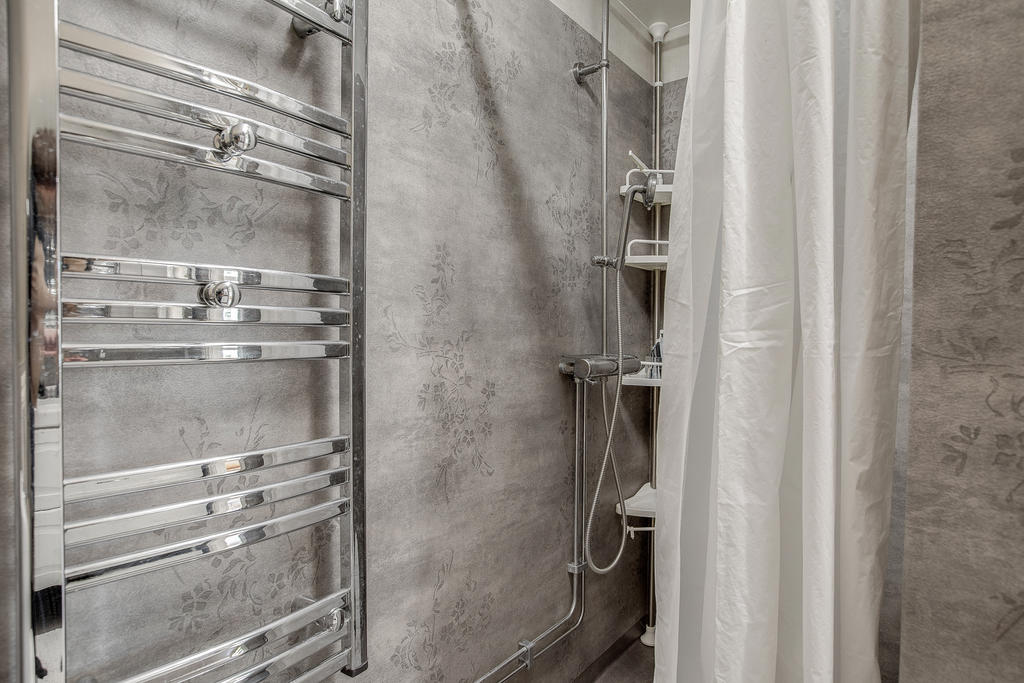 Badrum på ovanvåning med dusch och handdukstork