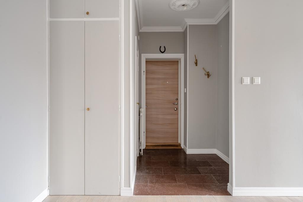 Hall med kalksten i original samt inbyggda garderober