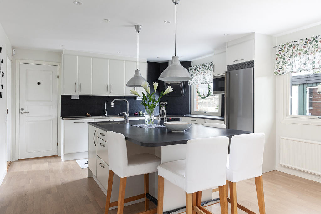 Härligt kök med stor köksö, integrerad vask och fint med förvaring och sittplatser att samlas kring