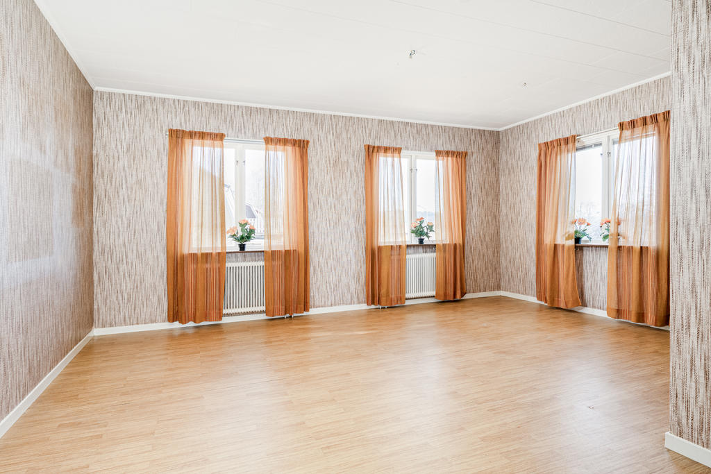 Luftigt vardagsrum med mycket ljusinsläpp.