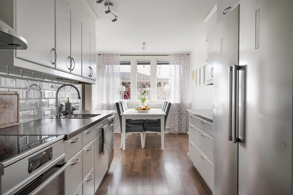 Trevligt arbetskök med matplats vid fönstret