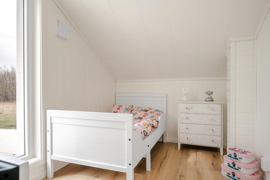 Sovrum 1 - helfönster med vy över trädgård och hagar