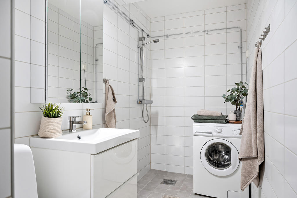 Renoverat badrum med tvättmaskin.