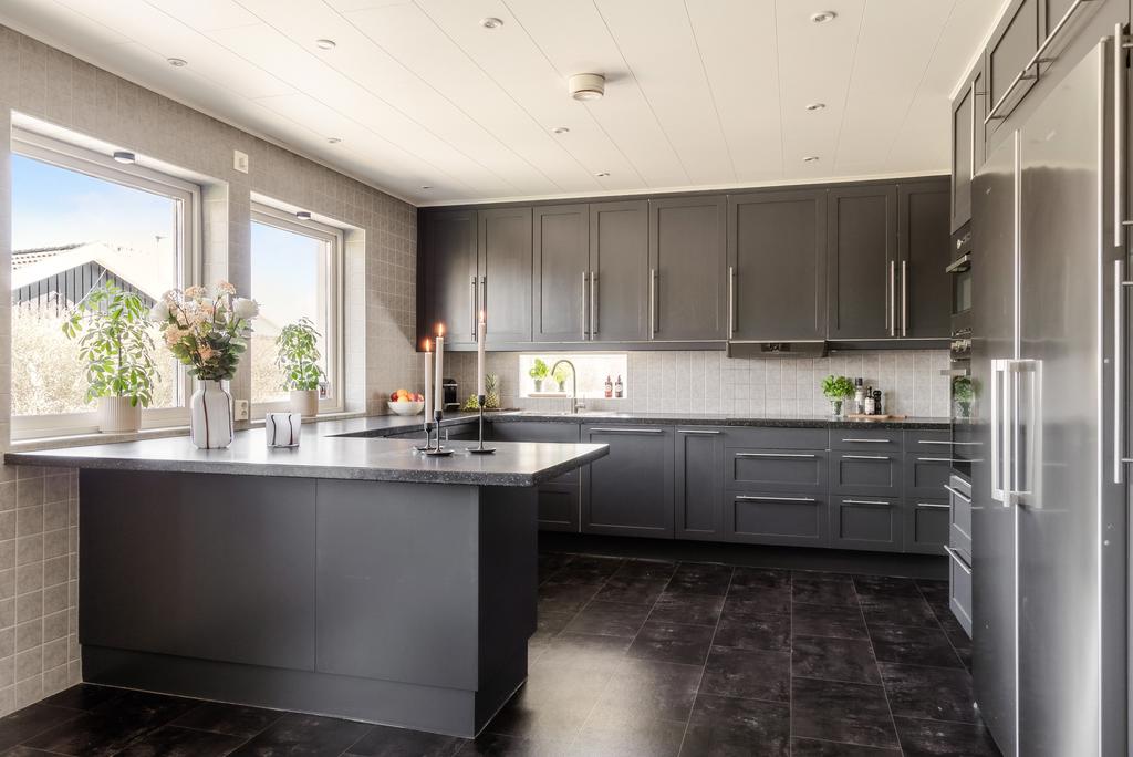 Ett rymligt, modernt och stilrent kök i en mer nedtonad färgskala