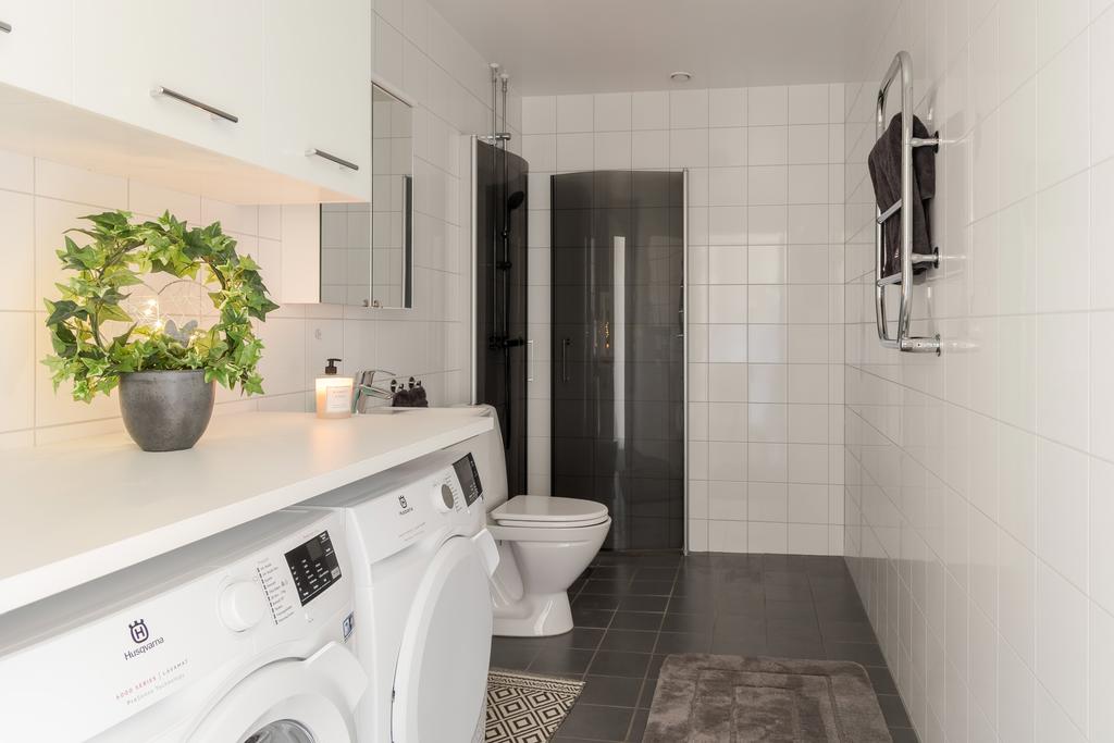 Helkaklat badrum med dusch samt tvättmaskin och torktumlare