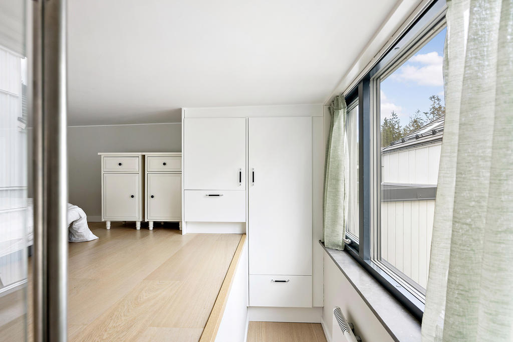 I trappan finns en extra garderobsförvaring. Stor fönsterparti med öppningsbar del skapar luftflöde och ljus i bostaden