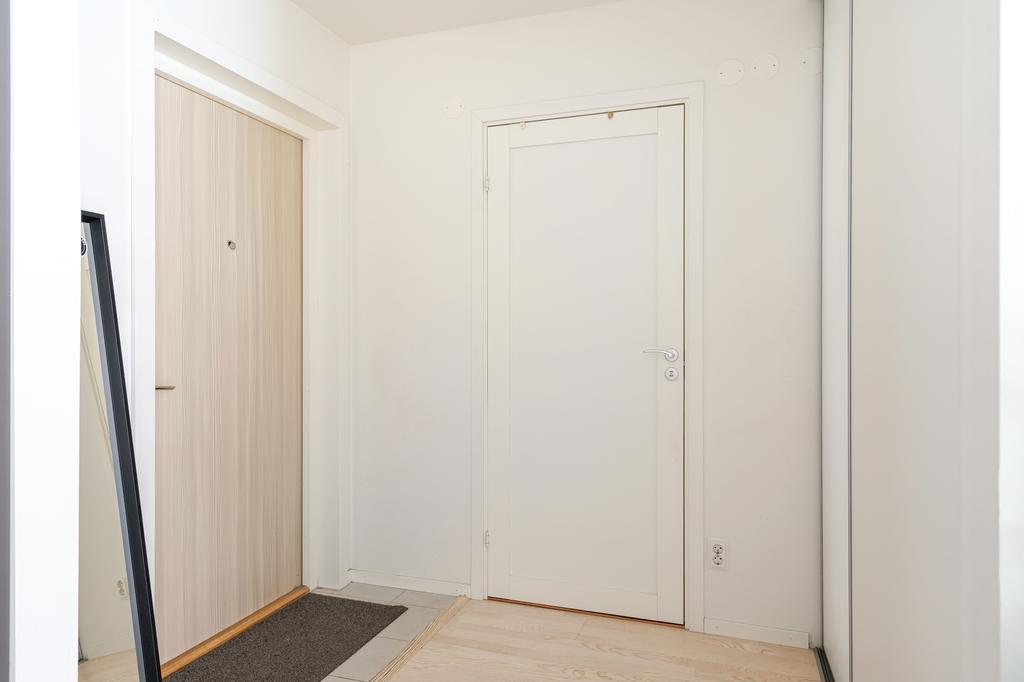 Hall med skjutdörrsgarderober och access till duschrum 