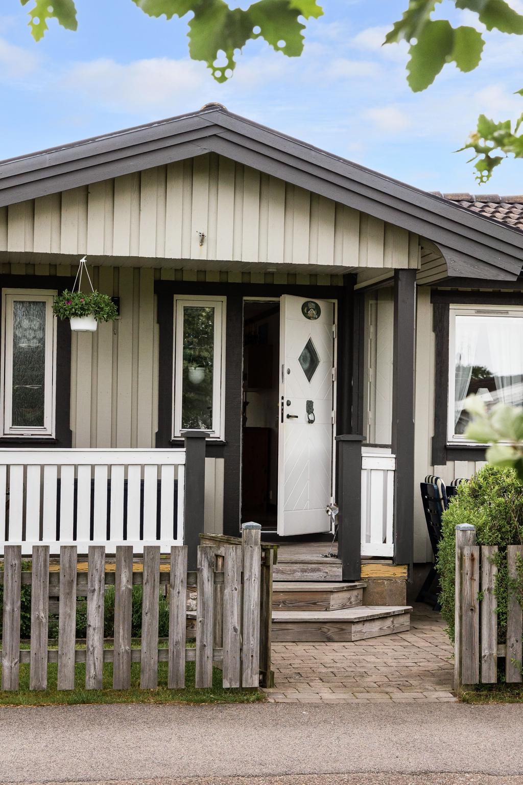Välkomnande entré med klassisk veranda som ger huset ett inbjudande första intryck. 