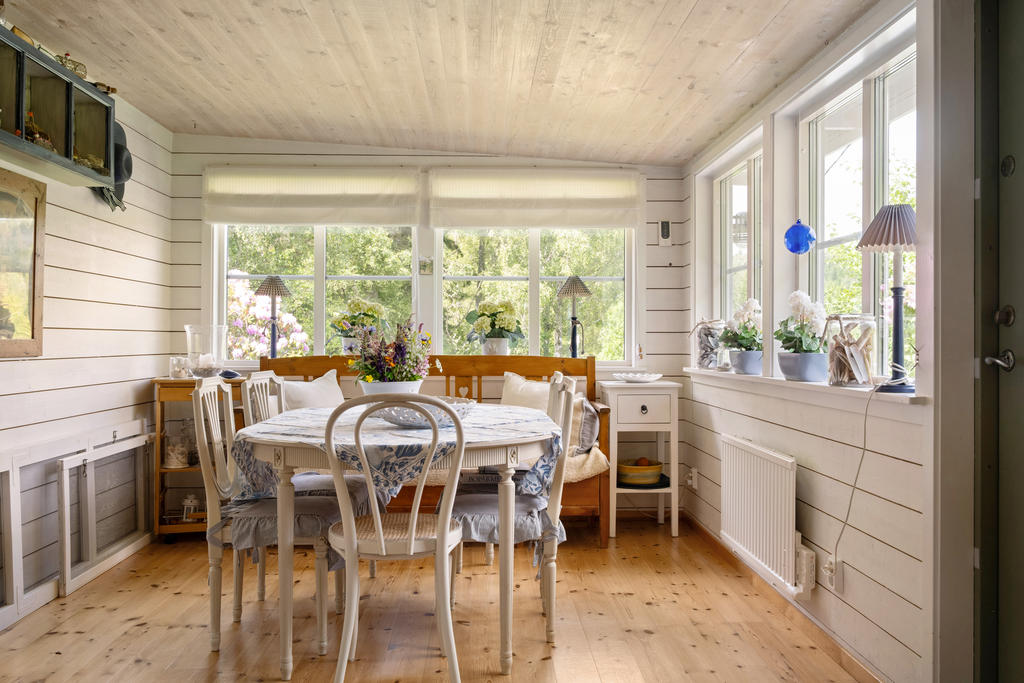 I anslutning till köket finns en separat matsalsplats med fint ljusinsläpp från spröjsade fönsterpartier. Här ryms ett matbord med plats för familj och gäster – en perfekt plats för långa, trivsamma måltider.