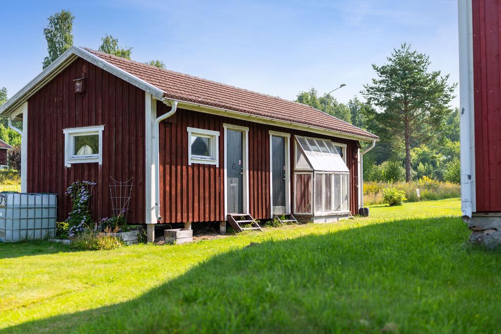 Förråd och verkstad. Odlingsplats av gamla fönster mot fasaden