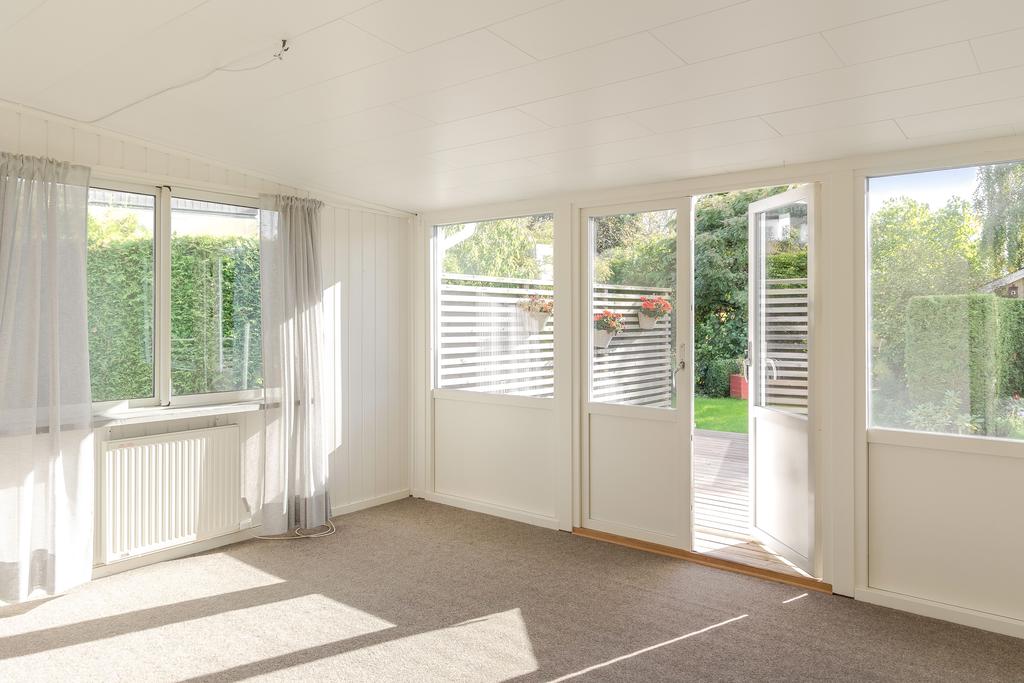 Det inglasade uterummet förlänger säsongen och skapar en naturlig övergång mellan huset och trädgården.
