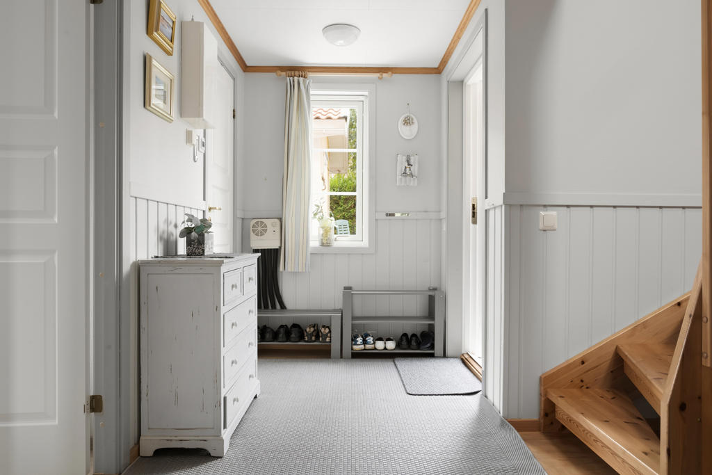 En fin och inbjudande hall som erbjuder generös plats för avhängning av ytterkläder och skor.